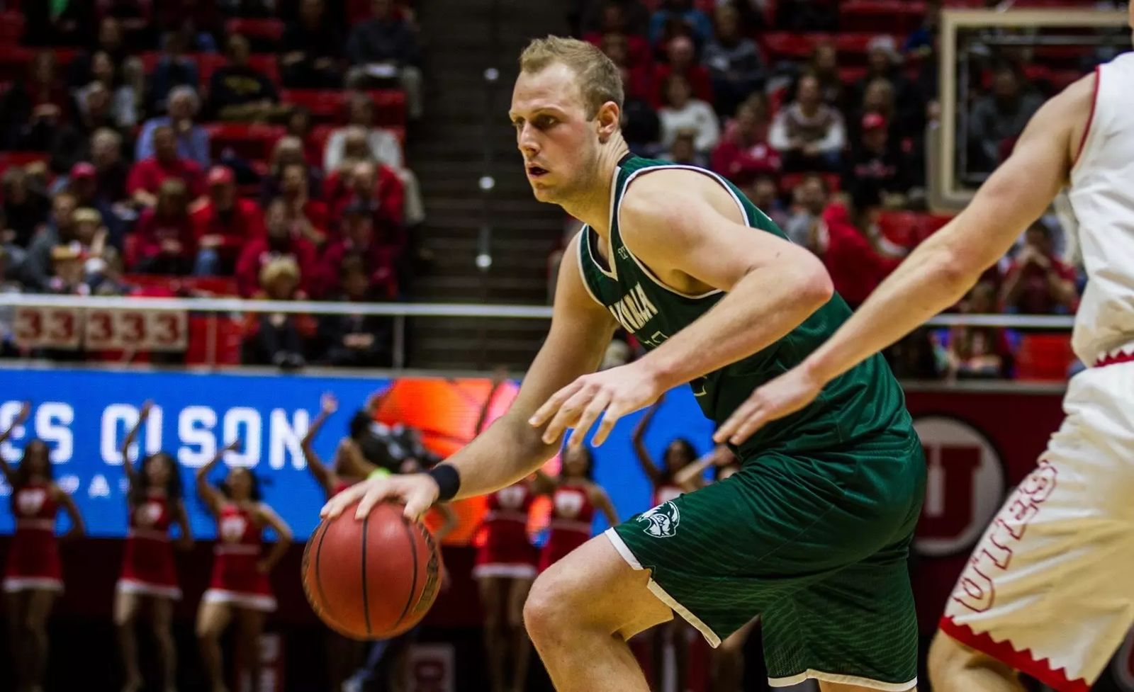 Isaac Neilson dribbling toward the basket against Utah